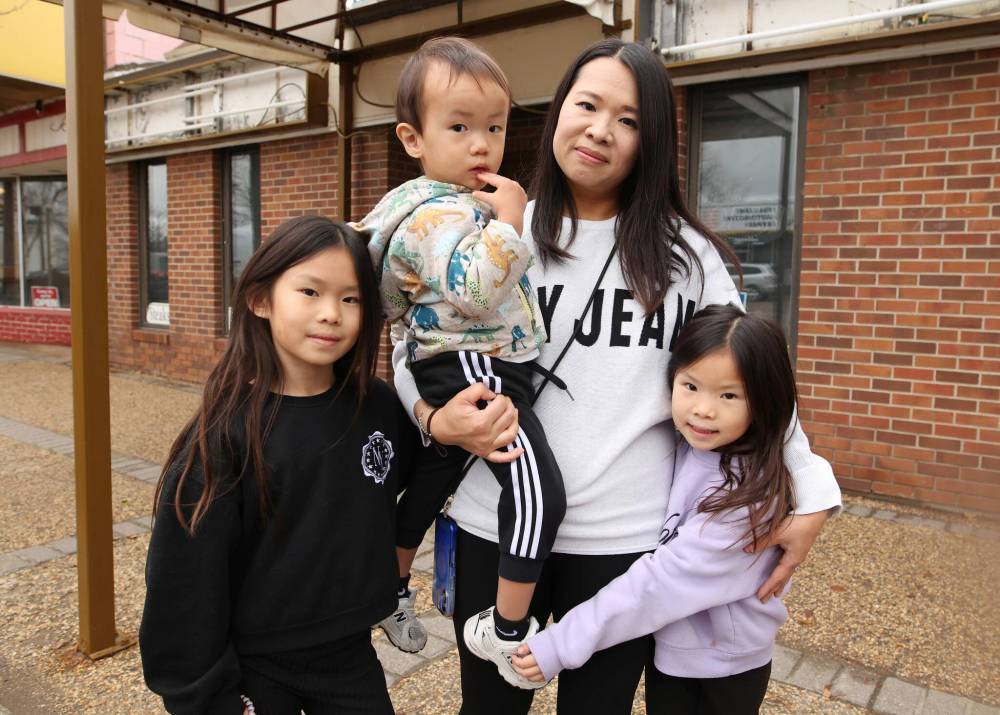 Claudia Leung and her children, Hayley Chan, Theodore Chan and Hannah Chan, stand outside the future home of Tastee's Brunch and Catering in the former Benny's Restaurant and Catering Services location on Rosser Avenue. (Tim Smith/The Brandon Sun)