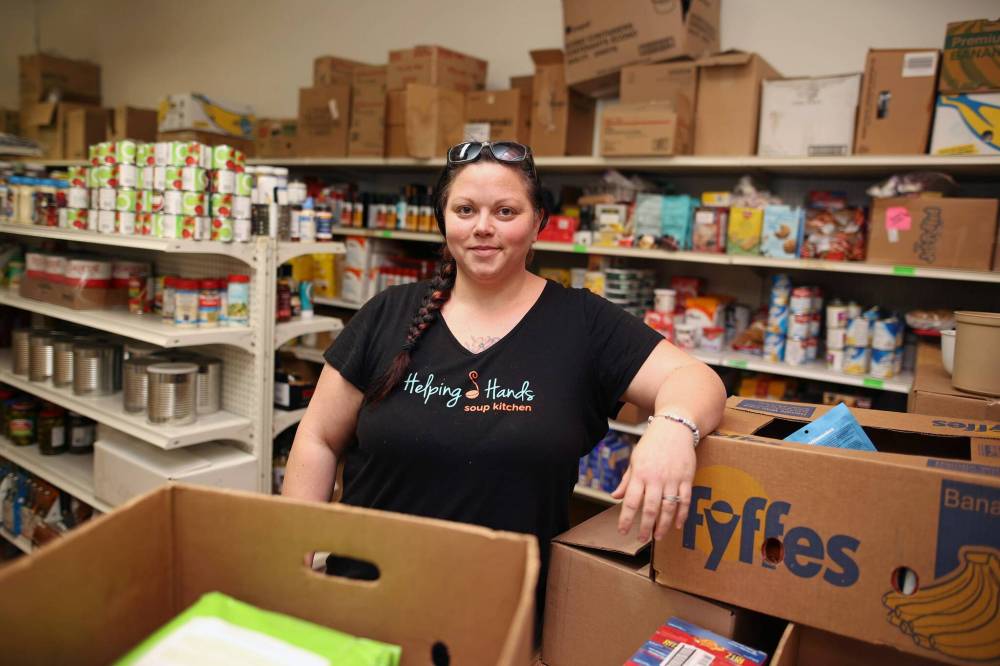 Angela Braun, executive director of Helping Hands Centre of Brandon Inc., inside a stocked pantry at the local soup kitchen on Tuesday. The organization has seen up to a 15 per cent increase in reliance on their services. (Tim Smith/The Brandon Sun)