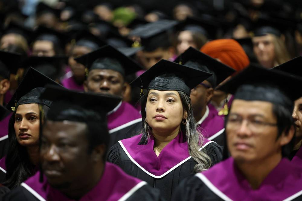 Assiniboine College graduates listen to speakers during Thursday’s ceremony at the Keystone Centre.