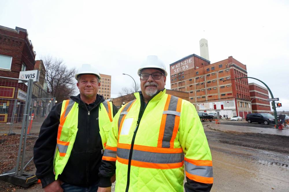The City of Brandon’s general manager of operations, Todd Burton (right), stands with Dave Dyck, acting manager of underground utilities, during an interview with the Sun on Rosser Avenue on Friday afternoon. (Matt Goerzen/The Brandon Sun)