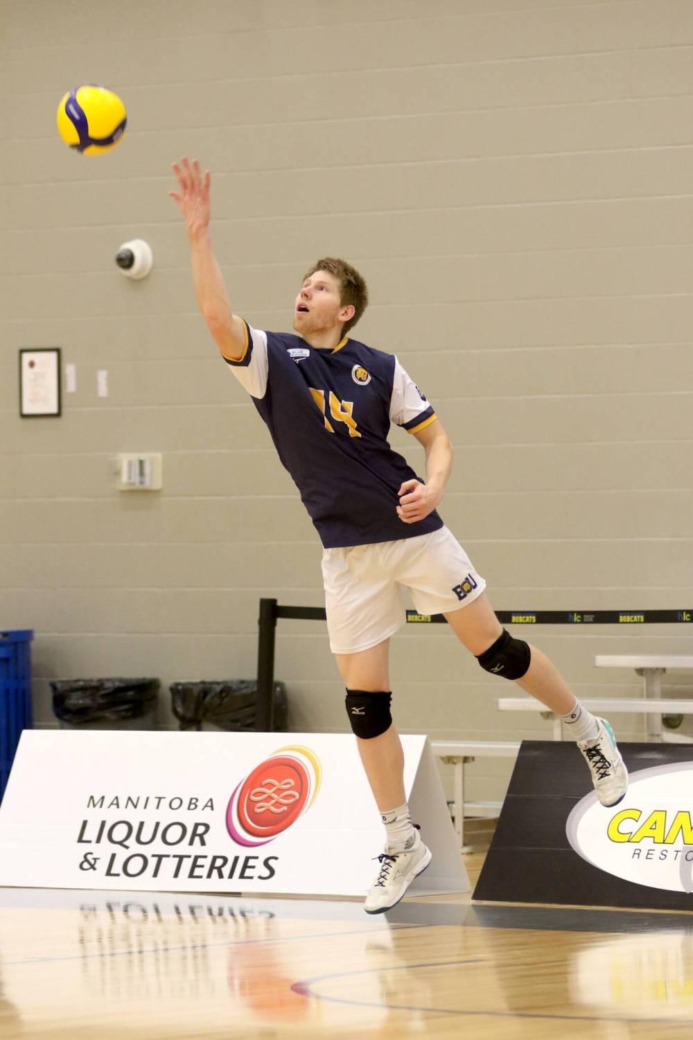 Brandon’s Tom Friesen serves against the Mount Royal Cougars during their Canada West men’s volleyball match on Friday. (Thomas Friesen/The Brandon Sun)