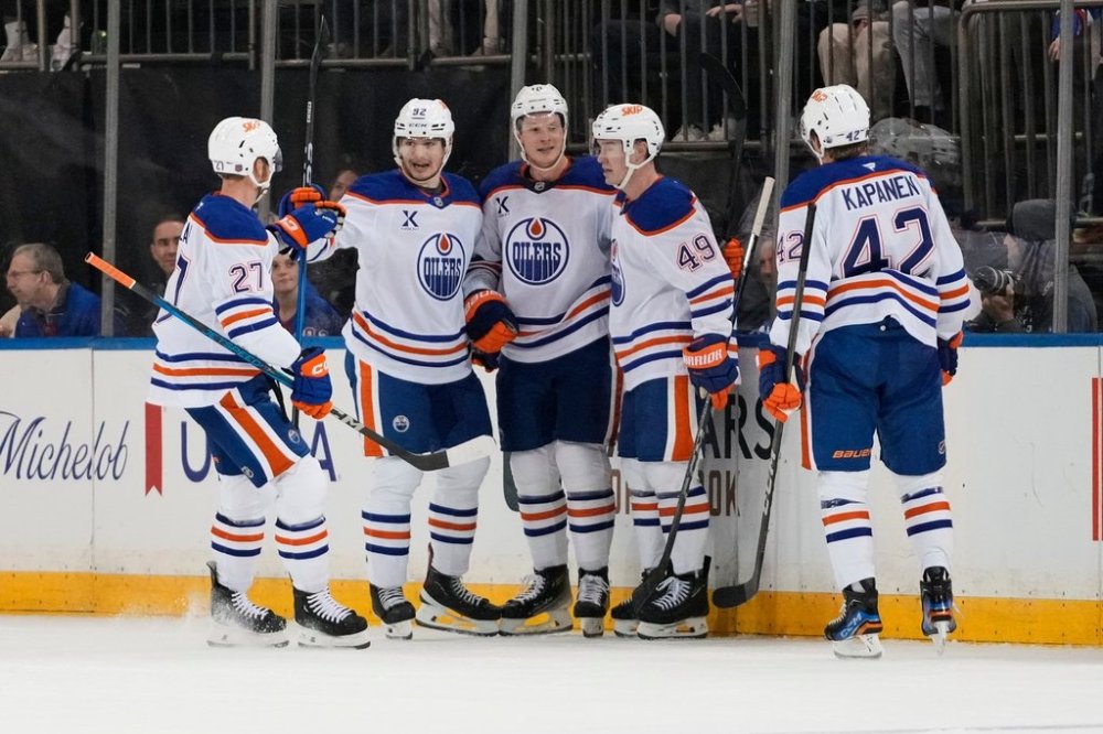 The Edmonton Oilers celebrate a goal by Trent Frederic, centre, during the second period of an NHL hockey game against the New York Rangers Tuesday, Oct. 14, 2025, in New York. (AP Photo/Frank Franklin II)