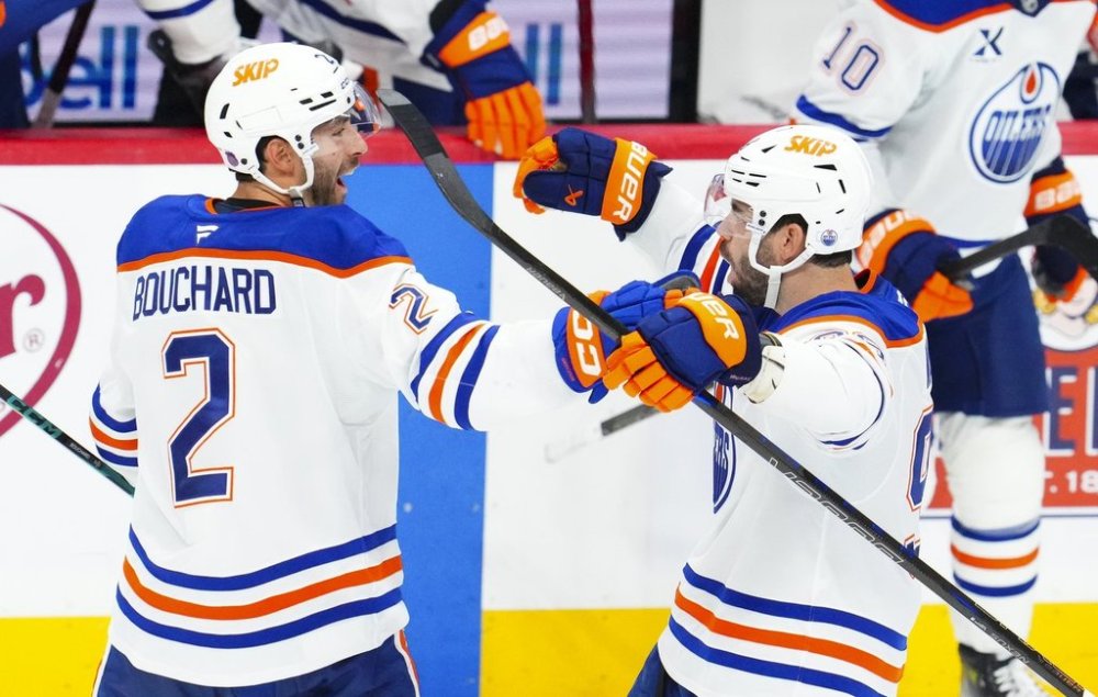 Edmonton Oilers' Jake Walman (96), right, celebrates his game winning goal with teammate Edmonton Oilers' Evan Bouchard (2) during overtime NHL hockey action against the Ottawa Senators in Ottawa on Tuesday, Oct. 21, 2025. THE CANADIAN PRESS/Sean Kilpatrick
