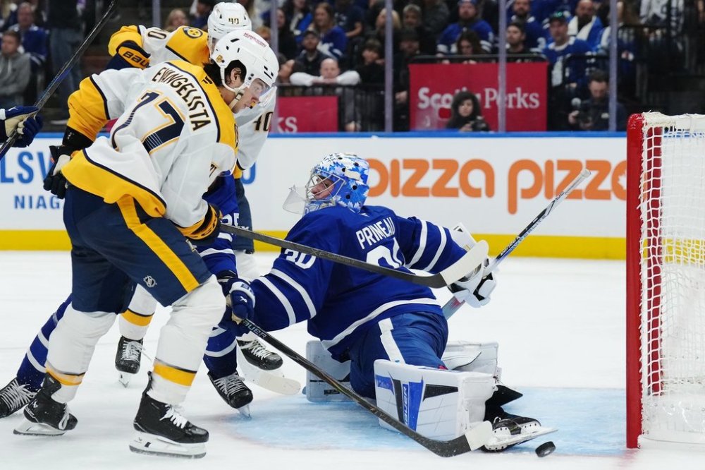 Maple Leafs goaltender Cayden Primeau (30) makes a save on Nashville Predators forward Luke Evangelista (77) during the third period in Toronto on Tuesday, Oct. 14, 2025. THE CANADIAN PRESS/Nathan Denette
