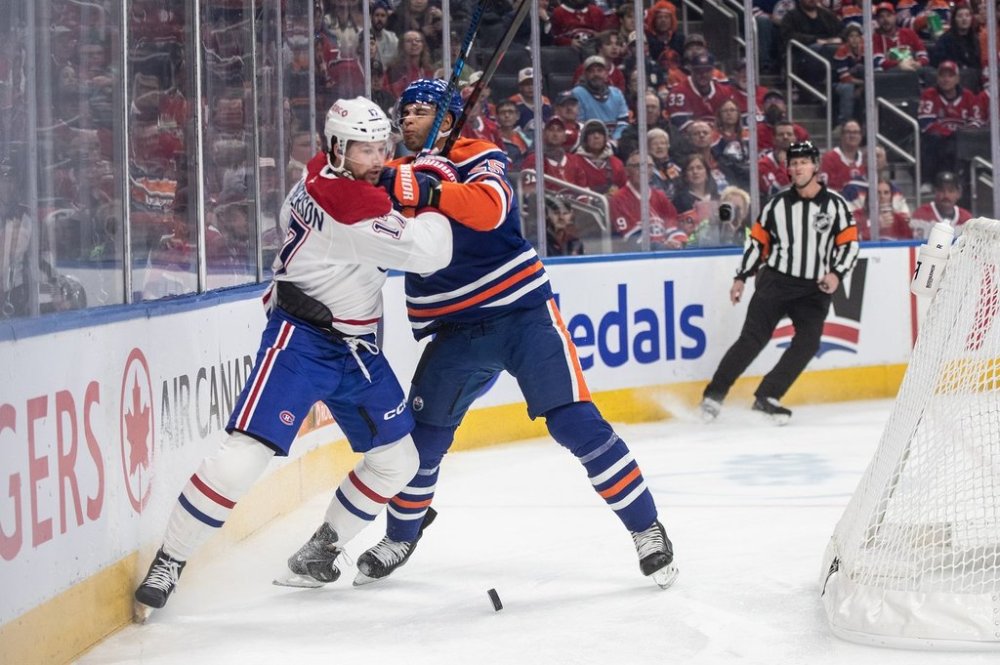 Montreal Canadiens' Josh Anderson (17) and Edmonton Oilers' Darnell Nurse (25) battle for the puck during first period NHL action, in Edmonton on Thursday, October 23, 2025. THE CANADIAN PRESS/Jason Franson