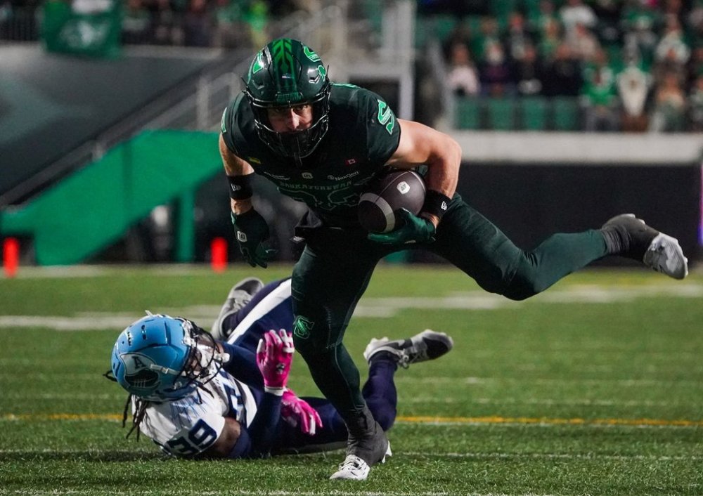 Saskatchewan Roughriders receiver Joe Robustelli (82) runs with the football against the Toronto Argonauts during the first half of CFL football action in Regina, on Friday, October 10, 2025. THE CANADIAN PRESS/Heywood Yu
