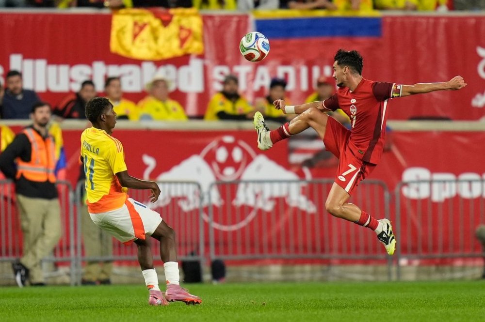 Canada's Stephen Eustáquio, right, kicks the ball during the second half of a friendly soccer match against Colombia in Harrison, N.J., Tuesday, Oct. 14, 2025. (AP Photo/Seth Wenig)