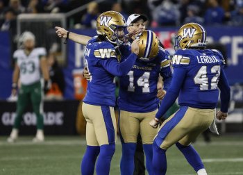 Winnipeg Blue Bombers' Jamieson Sheahan (18), kicker Sergio Castillo (14) and Ian Leroux (42) celebrate Castillo's game-winning field goal against the Saskatchewan Roughriders during second half CFL action in Winnipeg Friday, October 17, 2025.    THE CANADIAN PRESS/John Woods