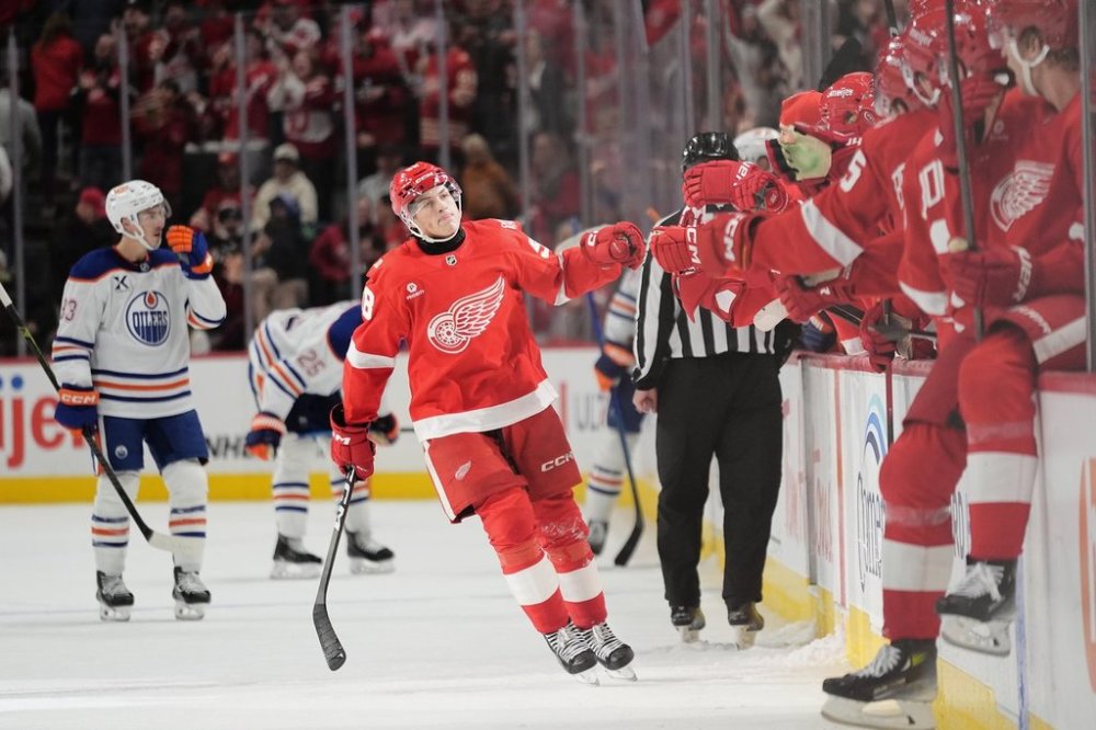 Detroit Red Wings center Emmitt Finnie, center, celebrates with the bench after scoring during the third period of an NHL hockey game against the Edmonton Oilers, Sunday, Oct. 19, 2025, in Detroit. (AP Photo/Ryan Sun)