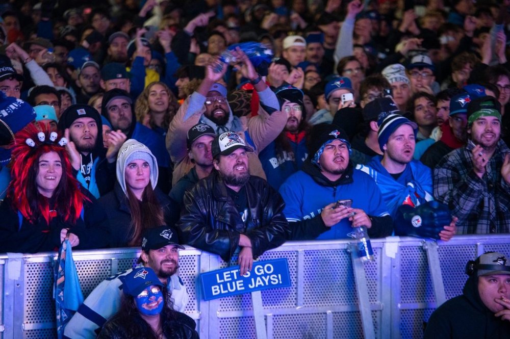 People watch the Toronto Blue Jays play against the Los Angeles Dodgers at a World Series Game 6 watch party at Nathan Phillips Square in Toronto, on Friday, October 31, 2025. THE CANADIAN PRESS/Laura Proctor