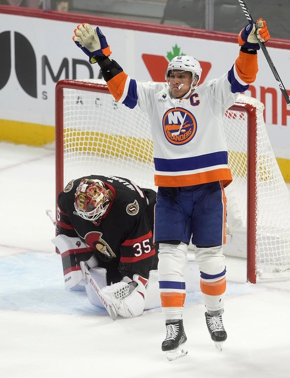 New York Islanders left wing Anders Lee (27) celebrates his game winning goal after scoring on tgoaltender Linus Ullmark (35) during third period NHL action in Ottawa, Saturday, Oct. 18, 2025. THE CANADIAN PRESS/Adrian Wyld