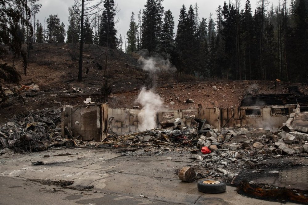 The remains of a home smoulder in Jasper, Alta., on Friday July 26, 2024. THE CANADIAN PRESS/Amber Bracken