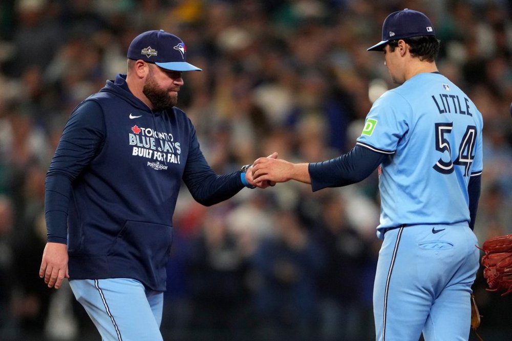 Toronto Blue Jays John Schneider pulls pitcher Brendon Little (54) during the eighth inning in Game 5 of baseball's American League Championship Series against the Seattle Mariners, Friday, Oct. 17, 2025, in Seattle. (AP Photo/Lindsey Wasson)