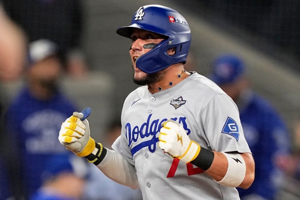 Los Angeles Dodgers' Miguel Rojas celebrates after a home run against the Toronto Blue Jays during the ninth inning in Game 7 of baseball's World Series, Saturday, Nov. 1, 2025, in Toronto. (AP Photo/Brynn Anderson)