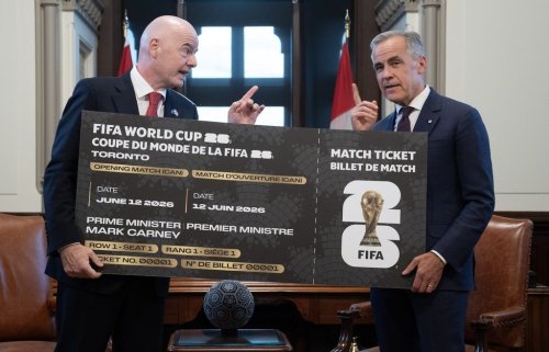 Prime Minister Mark Carney, right, is presented with a novelty World Cup ticket by FIFA President Gianni Infantino at the start of a meeting in his office on Parliament Hill in Ottawa, Friday, Oct. 10, 2025. THE CANADIAN PRESS/Adrian Wyld