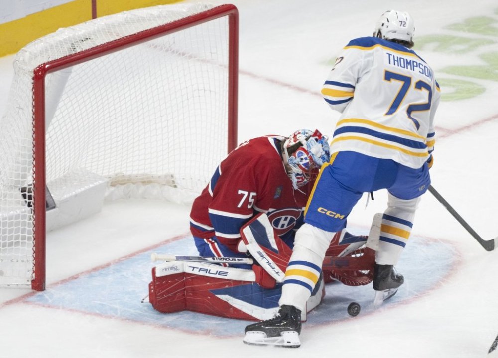 Montreal Canadiens goaltender Jakub Dobes (75) makes a save against Buffalo Sabres' Tage Thompson (72) during second period NHL hockey action in Montreal on Monday, Oct. 20, 2025. THE CANADIAN PRESS/Christinne Muschi