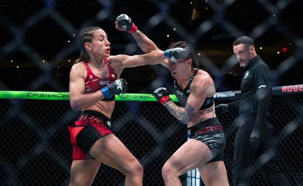 Jamey-Lyn Horth Ivana, right, is punched by Petrovic during the women's flyweight bout at UFC Fight Night in Edmonton on Saturday, November 2, 2024. THE CANADIAN PRESS/Jason Franson