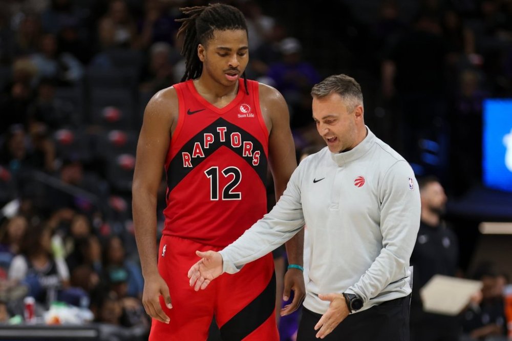 Toronto Raptors forward Collin Murray-Boyles (12) listen to Toronto Raptors head coach Darko Rajakovic during the second half of an NBA basketball pre-season game against the Sacramento Kings, Wednesday, Oct. 8, 2025, in Sacramento, Calif. (AP Photo/Scott Marshall)