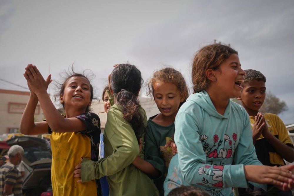 Palestinians celebrate following the announcement that Israel and Hamas have agreed to the first phase of a peace plan to pause the fighting, in Khan Younis, southern Gaza Strip, Thursday, Oct. 9, 2025. (AP Photo/Jehad Alshrafi)