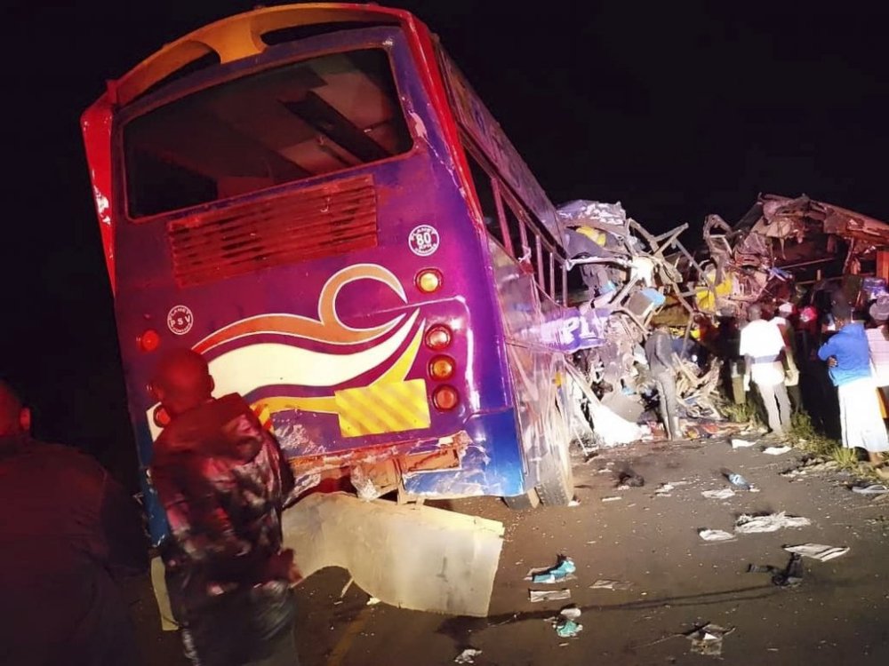 People gather at the scene of a multiple vehicles collision that left at least 63 dead near Gulu, northern Uganda, Wednesday, Oct. 22, 2025. (AP Photo/Uganda Red Cross )