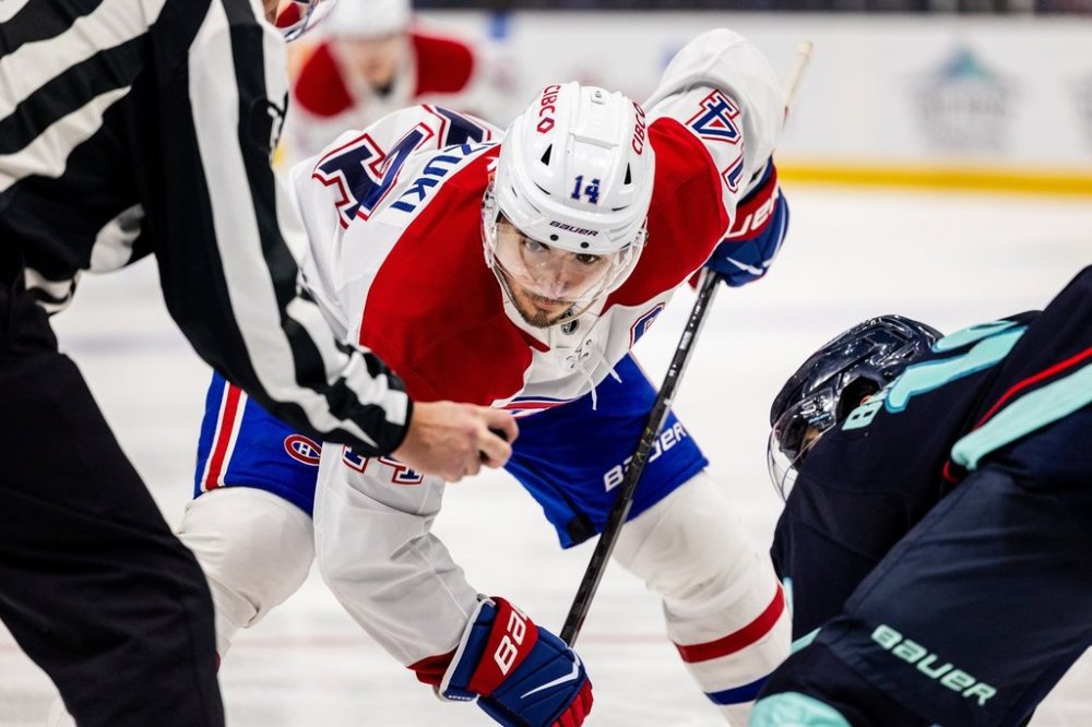Montreal Canadiens centre Nick Suzuki watches the puck during an NHL hockey game against the Seattle Kraken, Tuesday, Oct. 28, 2025, in Seattle. (AP Photo/Maddy Grassy)