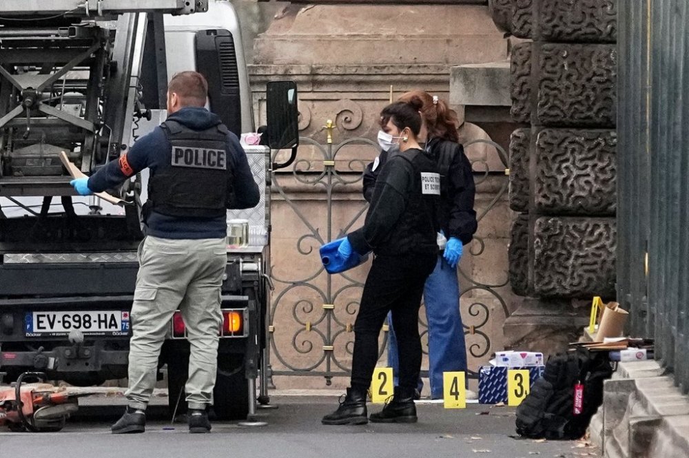 Police officers look for clues by a basket lift used by thieves Sunday, Oct. 19, 2025 at the Louvre museum in Paris. (AP Photo/Thibault Camus)