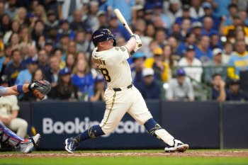 Milwaukee Brewers first baseman Andrew Vaughn (28) hits a solo home run against the Chicago Cubs during the fourth inning of Game 5 of baseball's National League Division Series, Saturday, Oct. 11, 2025, in Milwaukee. (AP Photo/Kayla Wolf)