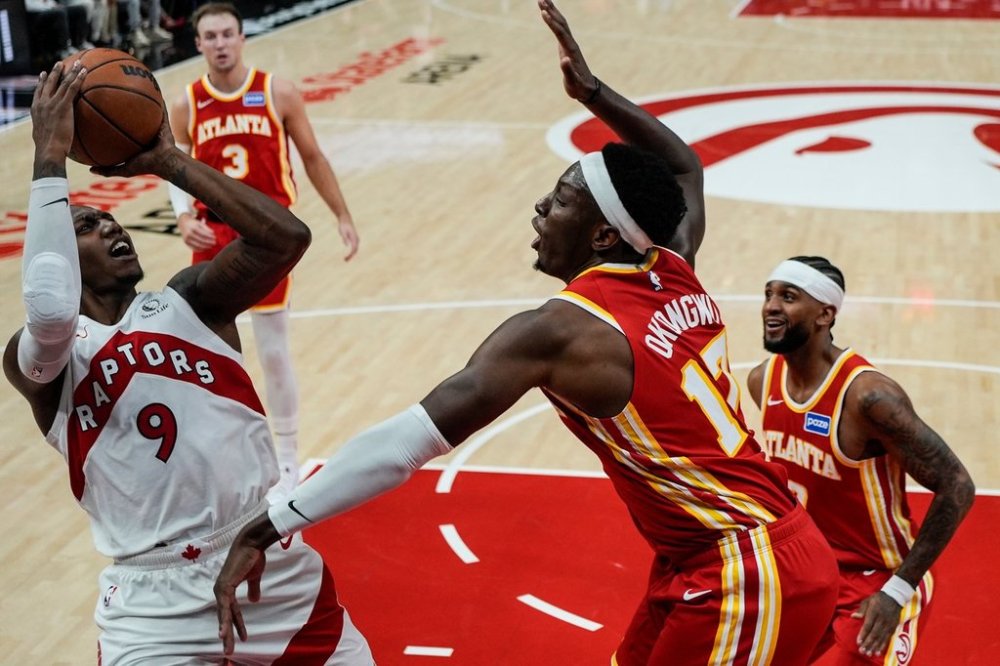 Toronto Raptors forward RJ Barrett (9) shoots against Atlanta Hawks forward Onyeka Okongwu (17) during the first half of an NBA basketball game, Wednesday, Oct. 22, 2025, in Atlanta. (AP Photo/Mike Stewart)