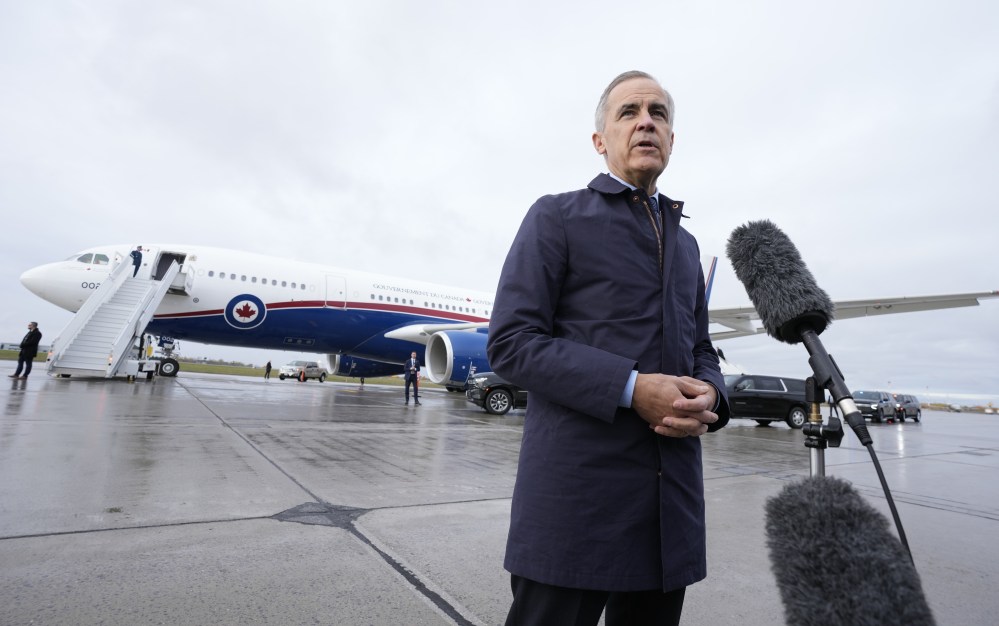 Prime Minister Mark Carney speaks with members of the media before he boards a government plane in Ottawa on Friday. We support Carney's position that Canada needs to reduce its economic dependence on the United States. (The Canadian Press)