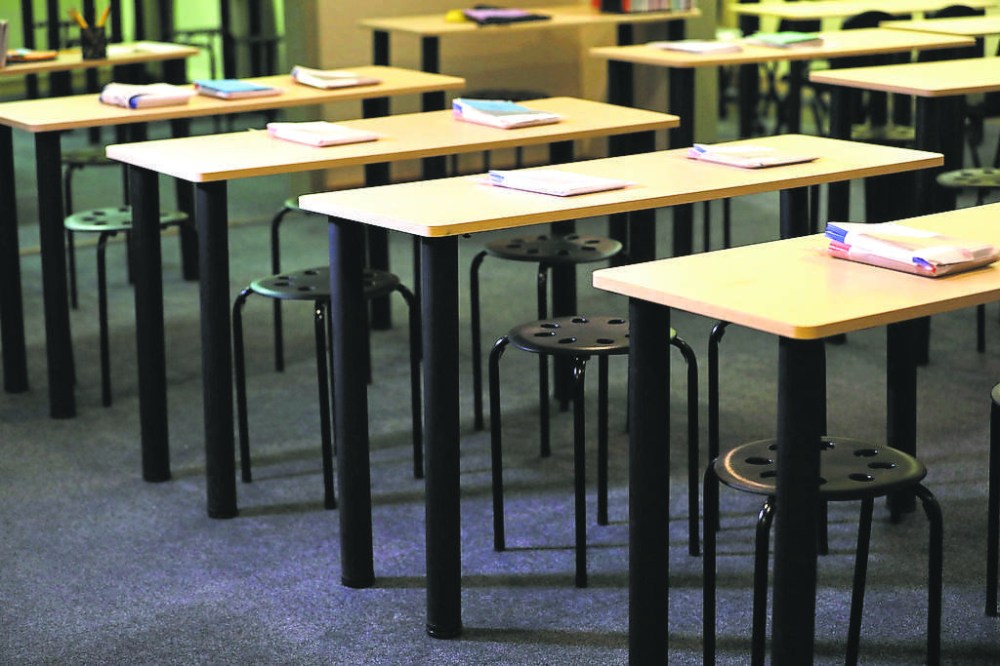 Desks in rows await their students at a Winnipeg school. Shannon D.M. Moore and Melanie D. Janzen write that a recent case in which a Carman principal has sued a parent for defamation has broader implications.  (Ruth Bonneville/Winnipeg Free Press files)