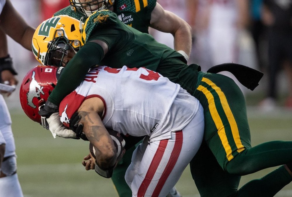 Calgary Stampeders quarterback Vernon Adams Jr. (3) is sacked by Edmonton Elks' Jonathan Kongbo (3) during second half CFL action in Edmonton, Saturday, Sept. 6, 2025. THE CANADIAN PRESS/Jason Franson
