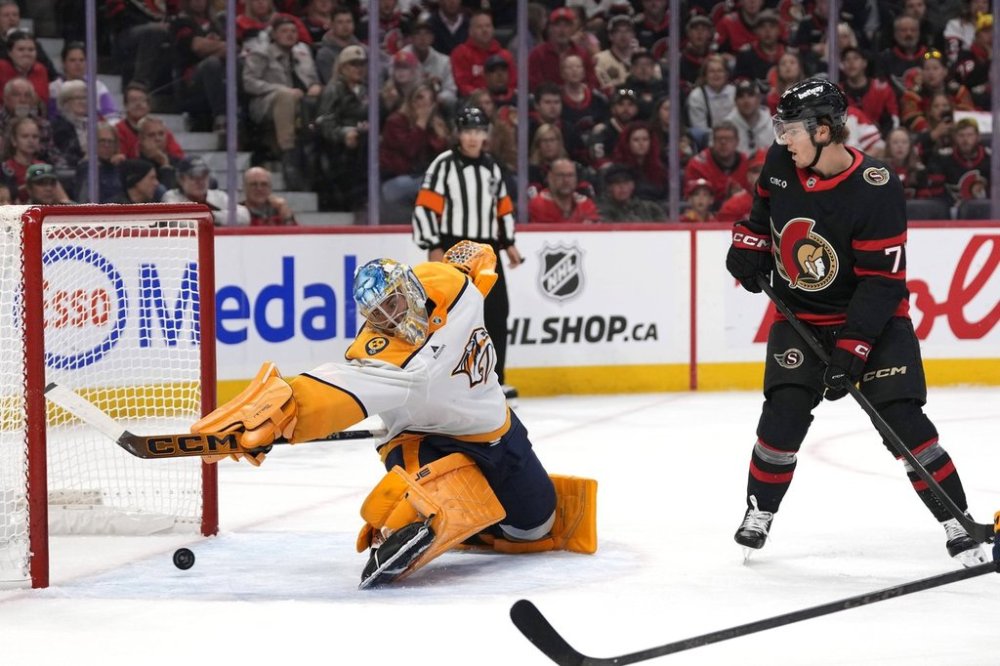 Nashville Predators goaltender Juuse Saros (74) makes a save in front of Ottawa Senators' Ridly Greig (71) during second period NHL hockey action in Ottawa, on Monday, Oct. 13, 2025. THE CANADIAN PRESS/Justin Tang