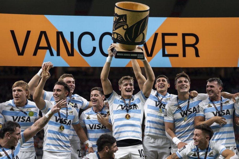 Argentina's Santiago Mare lifts a trophy as his team cheers during a trophy presentation after defeating South Africa to win gold during Vancouver Rugby Sevens, in Vancouver, B.C., Sunday, Feb. 23, 2025. THE CANADIAN PRESS/Ethan Cairns