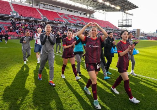 AFC Toronto midfielder Victoria Pickett (94) and midfielder Aoi Kizaki (13) greet fans after Northern Super League soccer action against Montreal Roses FC in Toronto on Saturday, April 19, 2025. THE CANADIAN PRESS/Arlyn McAdorey