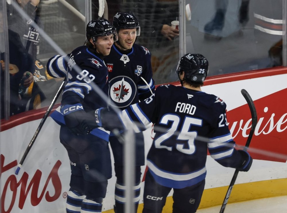 Winnipeg Jets' Brad Lambert (93), Cole Koepke (45) and Parker Ford (25) celebrate Lambert’s goal against the Pittsburgh Penguins during first period NHL action in Winnipeg, Saturday, Nov. 1, 2025. THE CANADIAN PRESS/John Woods