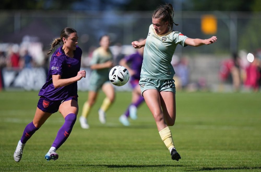 Calgary Wild's Danielle Steer, left, and Vancouver Rise's Chloe Taylor vie for the ball during the first half of an NSL soccer match, in Burnaby, B.C., on Saturday, May 24, 2025. THE CANADIAN PRESS/Darryl Dyck