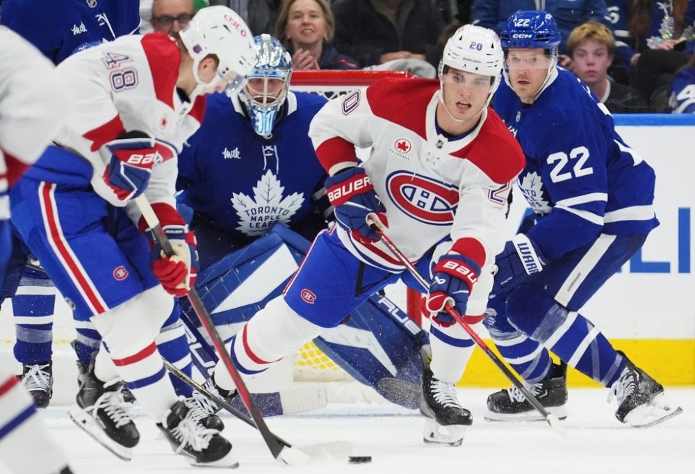 Montreal Canadiens' Lane Hutson (48) and Juraj Slafkovsky (20) work for the puck as Toronto Maple Leafs goaltender Anthony Stolarz (41) and Jake McCabe (22) look on during second period NHL hockey action in Toronto on Wednesday, Oct. 8, 2025. THE CANADIAN PRESS/Frank Gunn