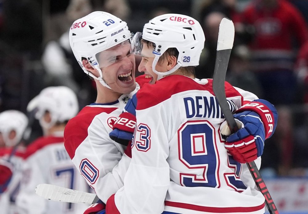 Montreal Canadiens' Juraj Slafkovsky (20) and Ivan Demidov (93) celebrate after Montreal defeated the Vancouver Canucks 4-3 during an NHL hockey game in Vancouver, on Saturday, Oct. 25, 2025. THE CANADIAN PRESS/Darryl Dyck