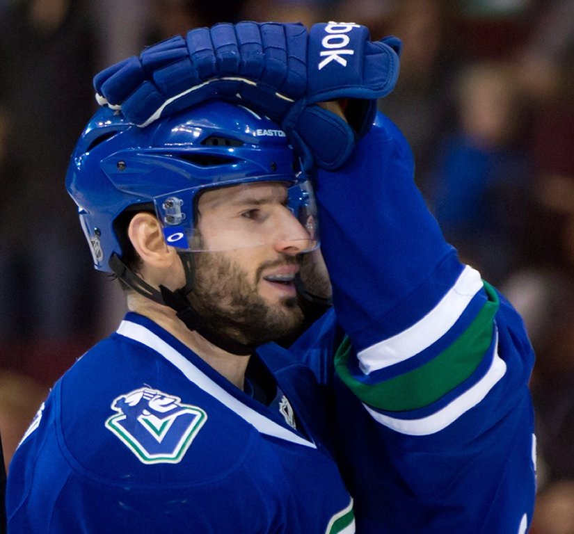 Vancouver Canucks' Ryan Kesler and Ryan Stanton, back, celebrate Kesler's 25th goal of the season, during second period NHL hockey action in Vancouver, B.C., on Sunday April 13, 2014. THE CANADIAN PRESS/Darryl Dyck