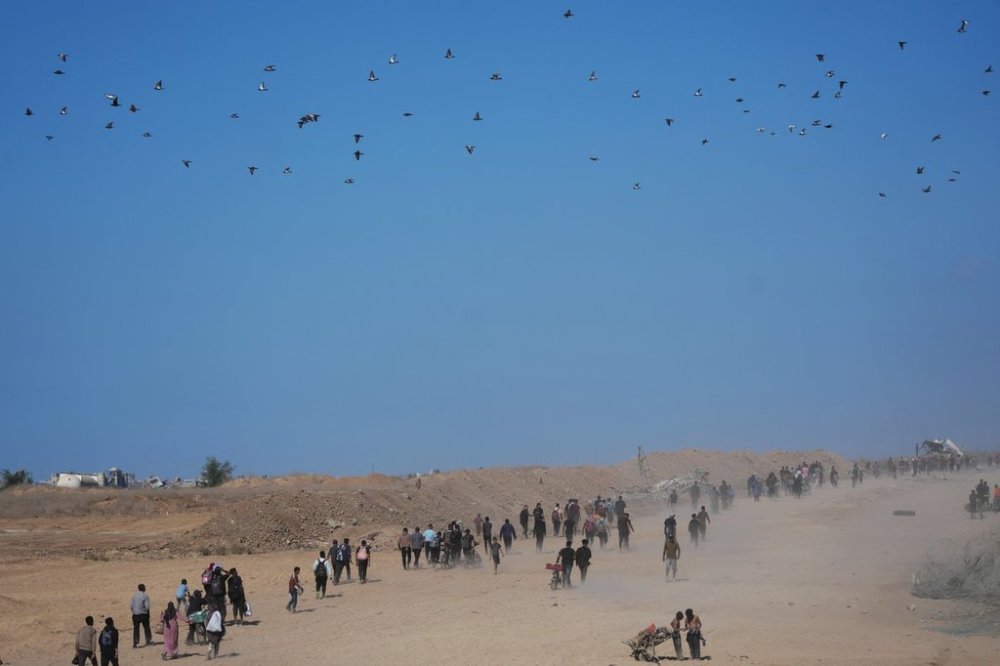 Displaced Palestinians walk toward Gaza City, in the northern Gaza Strip, Friday, Oct. 10, 2025, after Israel and Hamas agreed to a pause in their war and the release of the remaining hostages. (AP Photo/Jehad Alshrafi)