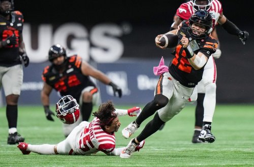B.C. Lions quarterback Nathan Rourke (12) gets away from Calgary Stampeders' Jaydon Grant (25), as he loses his helmet, during the second half of a CFL football game, in Vancouver, on Saturday, Oct. 4, 2025. THE CANADIAN PRESS/Darryl Dyck