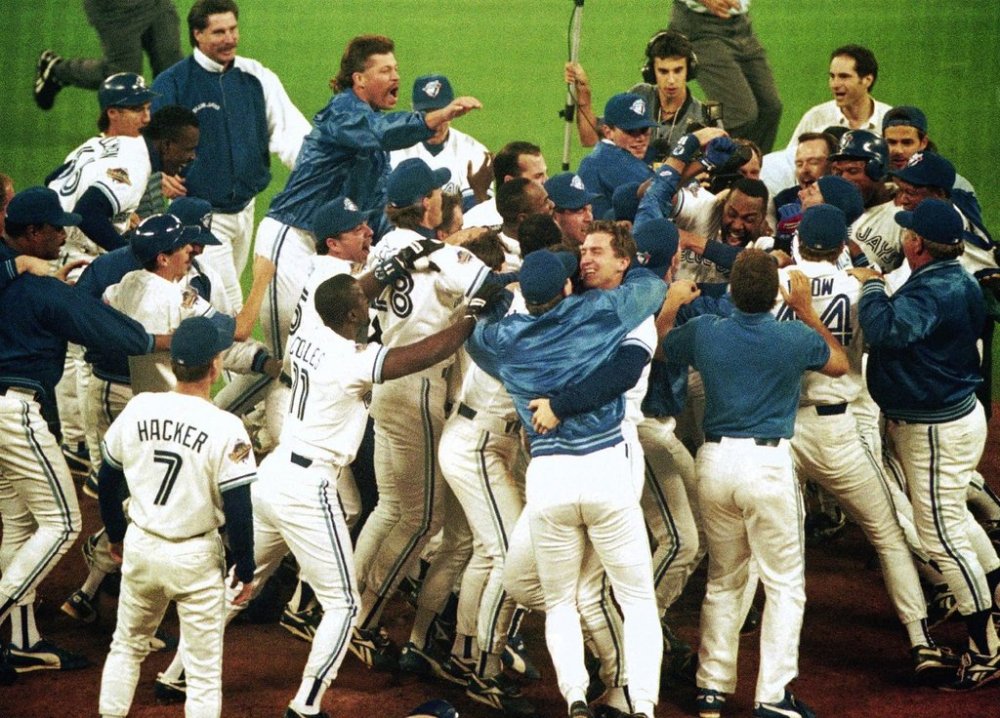 Toronto Blue Jays members mob teammate Joe Carter after his game winning home run in bottom of 9th in game 6 of World Series, October 23, 1993. (AP Photo)