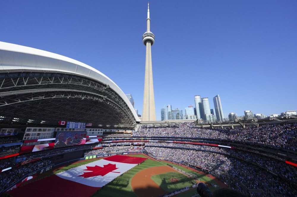 The Canadian flag is displayed on the field during an anthem ceremony ahead of the start of Major League Baseball's American League Division Series between the Blue Jays and New York Yankees in Toronto on Oct. 4, 2025. THE CANADIAN PRESS/Chris Young