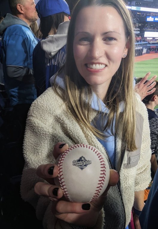 Meghan Roach holds Toronto Blue Jays' Bo Bichette's home run ball during Game 7 of the World Series against the Los Angeles Dodgers in Toronto in this Saturday, Nov. 1, 2025 handout photo. THE CANADIAN PRESS/Handout — Meghan Roach (Mandatory Credit)