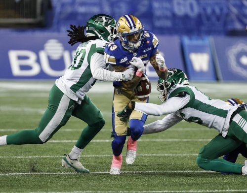 Winnipeg Blue Bombers’ Trey Vaval (23) fumbles the ball as he is tackled on the opening kick return by Saskatchewan Roughriders’ Kerfalla Exumé (20) during first half CFL action in Winnipeg, Friday, Oct. 17, 2025. THE CANADIAN PRESS/John Woods