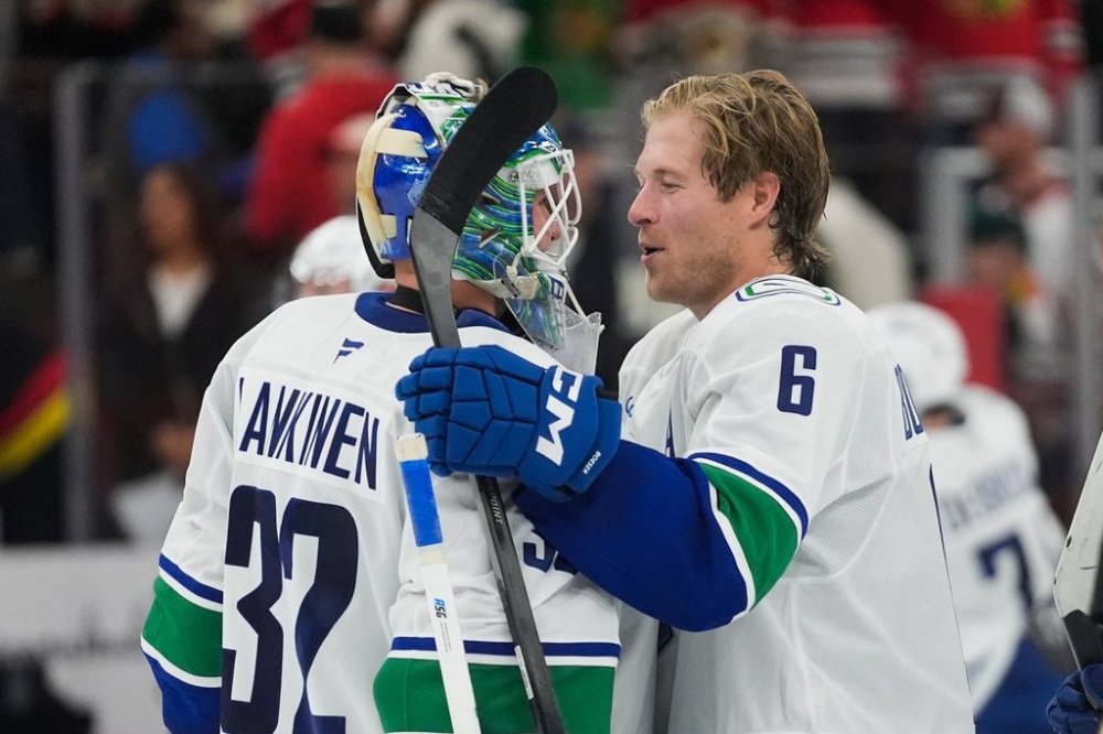 Vancouver Canucks right-winger Brock Boeser (6), right, celebrates his game-winning shootout goal against the Chicago Blackhawks with goaltender Kevin Lankinen (32) during the third period of an NHL hockey game Friday, Oct. 17, 2025, in Chicago. (AP Photo/Erin Hooley)