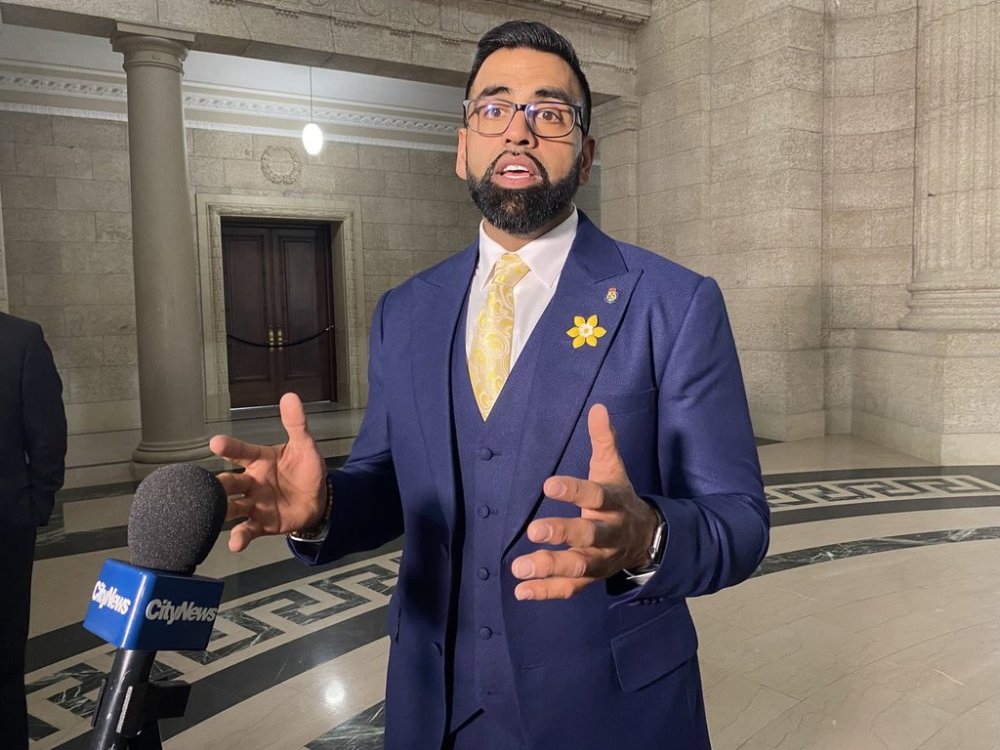 Obby Khan speaks to reporters after being sworn in as a member of the Manitoba legislature in Winnipeg, Monday, April 4, 2022. THE CANADIAN PRESS/Steve Lambert