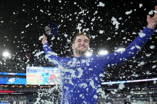 Toronto Blue Jays pitcher Trey Yesavage (39) gets a sports drink shower from teammate Myles Straw after their 13-7 win over the New York Yankees, after MLB American League Division Series baseball action in Toronto, Sunday, Oct. 5, 2025. THE CANADIAN PRESS/Frank Gunn