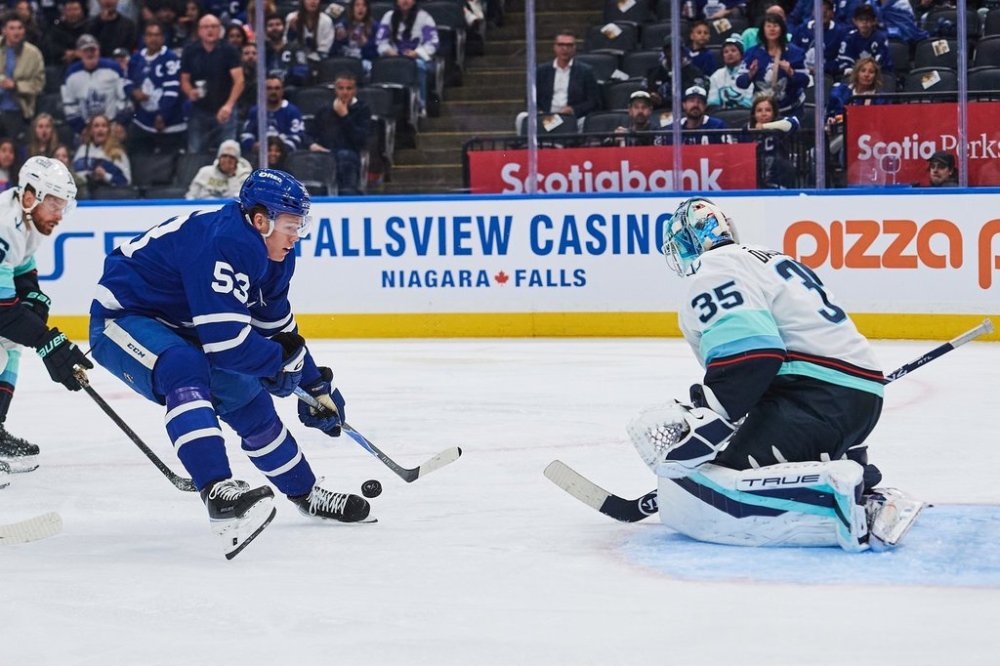 Toronto Maple Leafs' Easton Cowan (53) loses control of the puck in front of Seattle Kraken goaltender Joey Daccord (35) during second period NHL hockey action in Toronto, on Saturday, Oct. 18, 2025. THE CANADIAN PRESS/Sammy Kogan