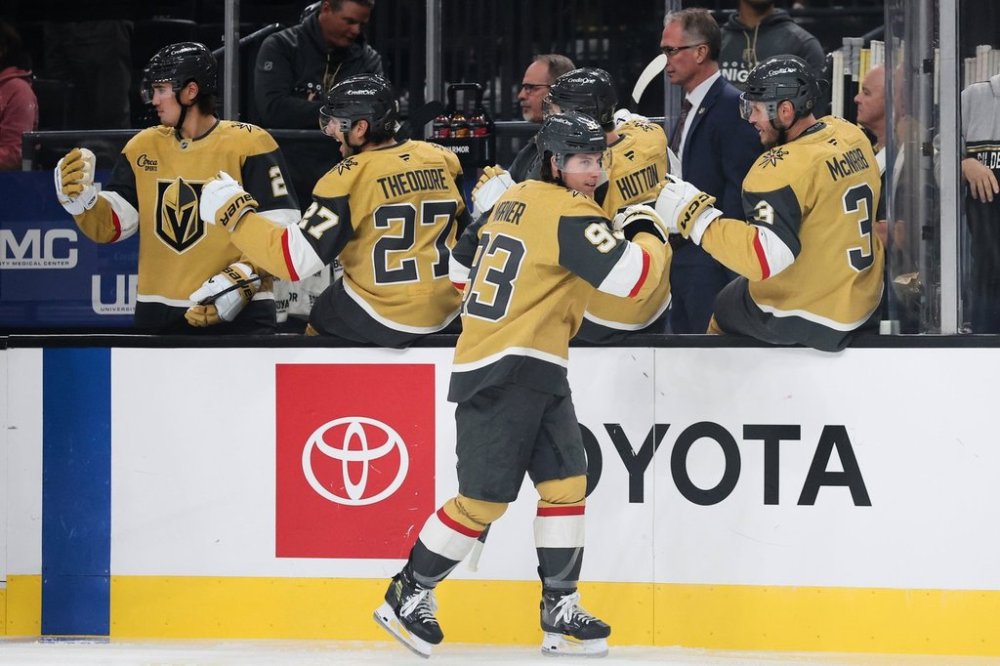 Vegas Golden Knights right wing Mitch Marner (93) celebrates with teammates after scoring against the Calgary Flames during the first period of an NHL hockey game Saturday, Oct. 18, 2025, in Las Vegas. (AP Photo/Ian Maule)